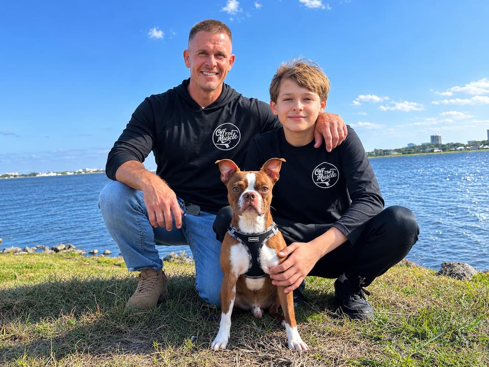 Jason, owner of Off The Muscle, with his son and dog by the water in West Palm Beach